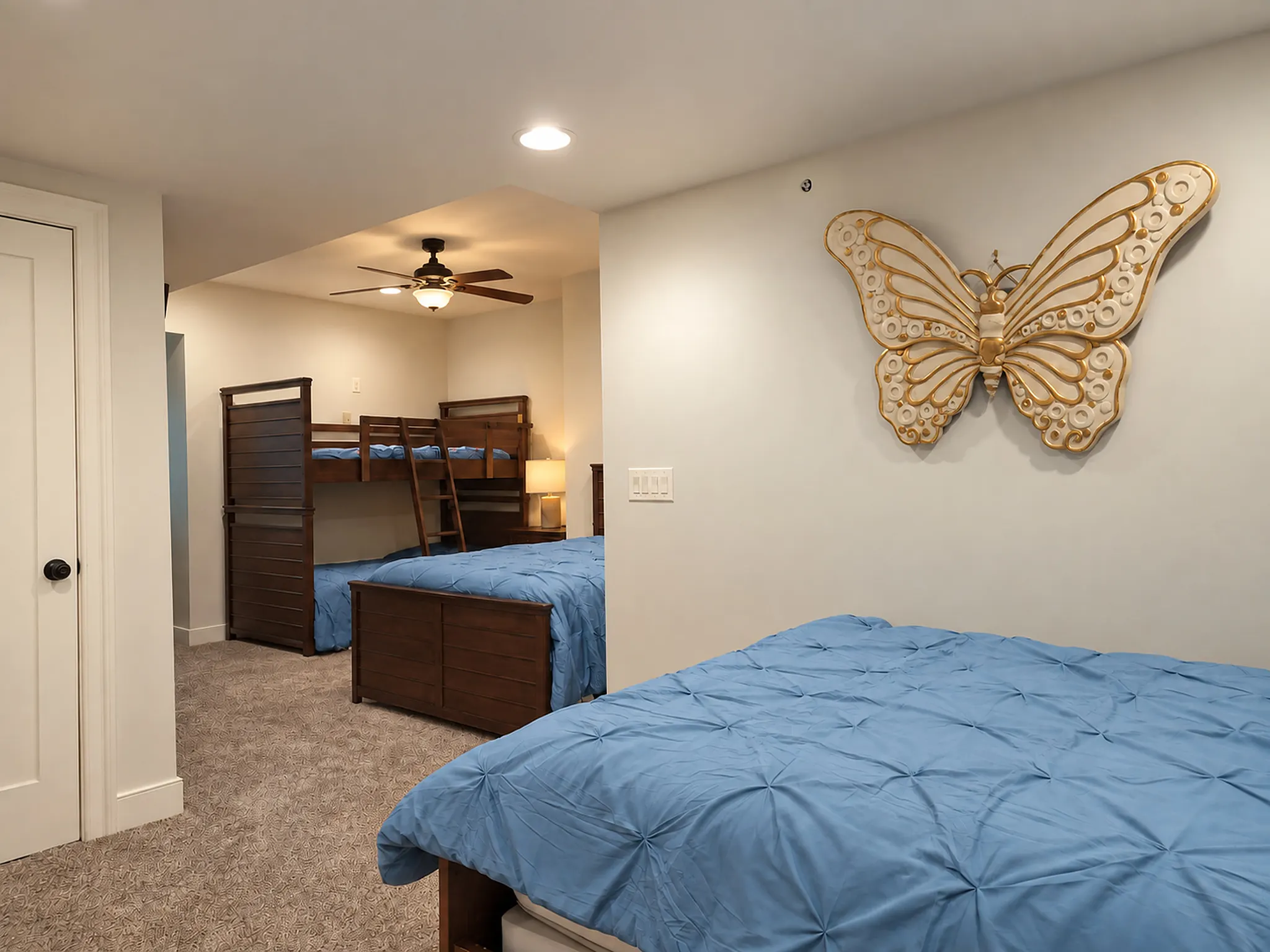 Kids' bunk room with a bunk bed and two double beds