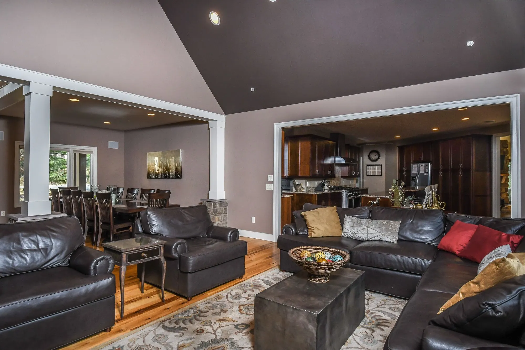 Great room opening toward the kitchen through the columns