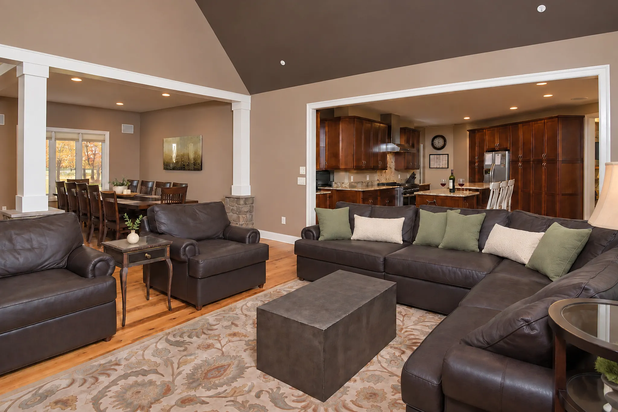 Great room opening toward the kitchen through the columns