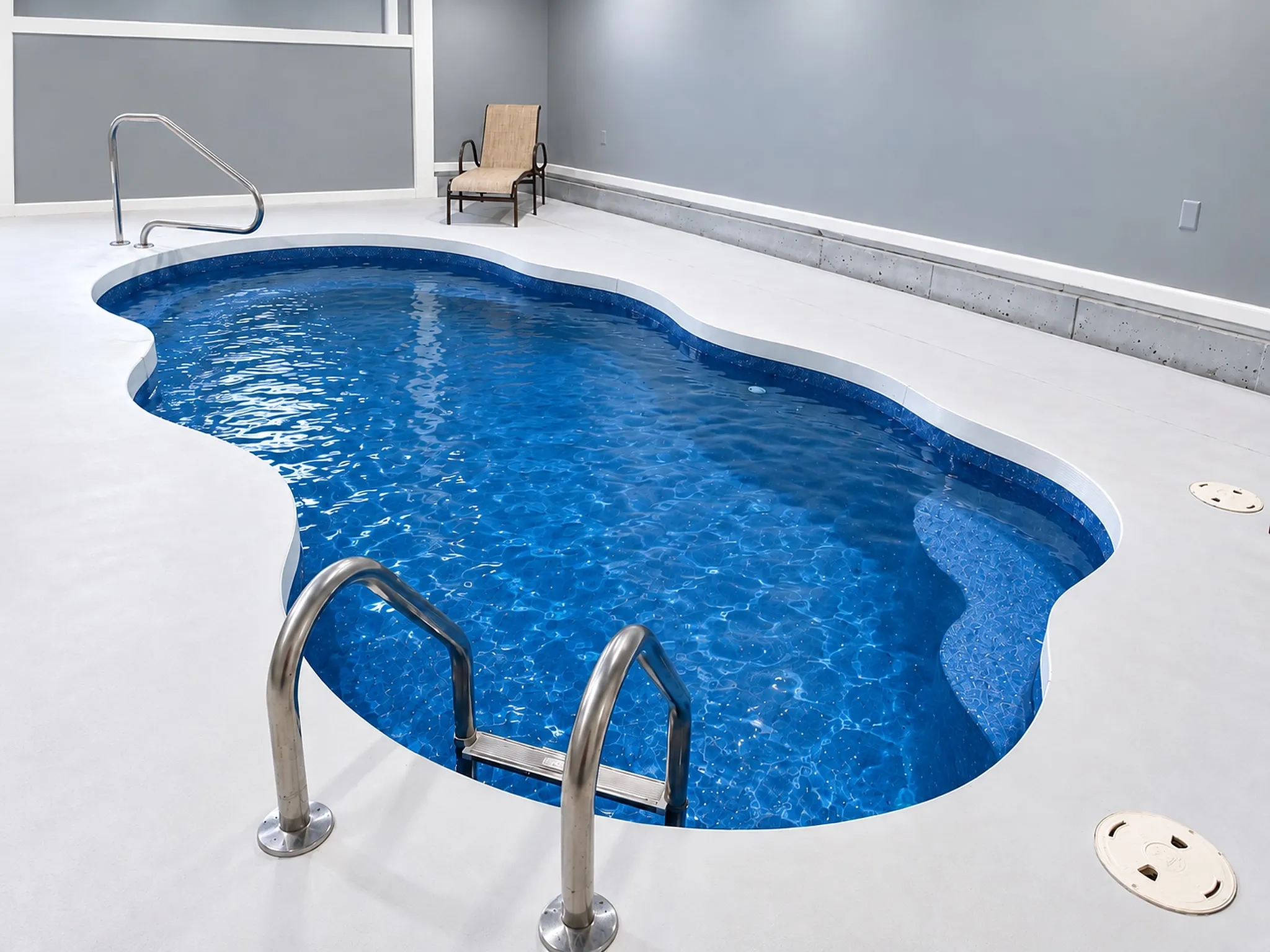 Freeform heated indoor pool inside the pool house