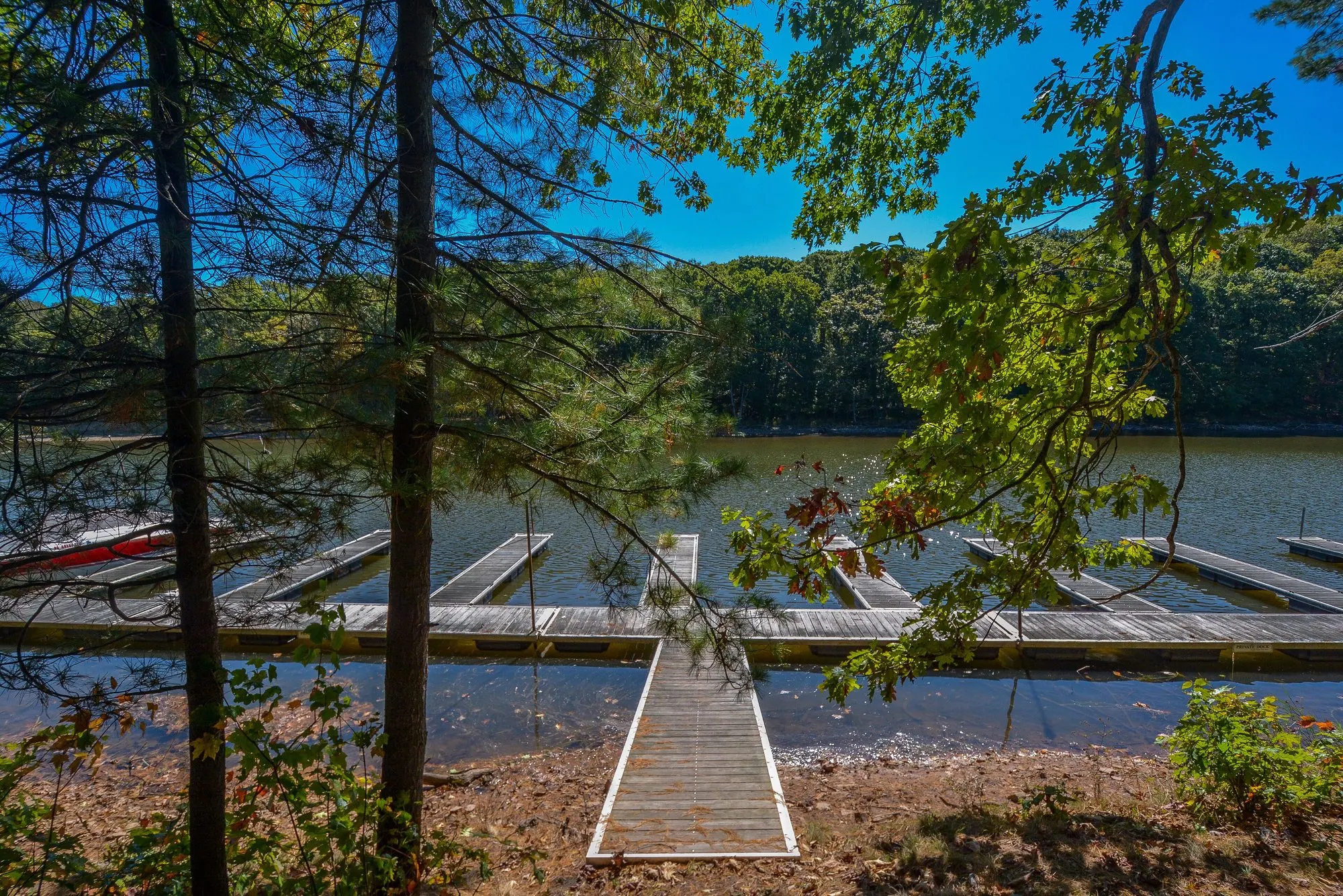 Woodland Chalet dock slip on Deep Creek Lake, viewed through the trees