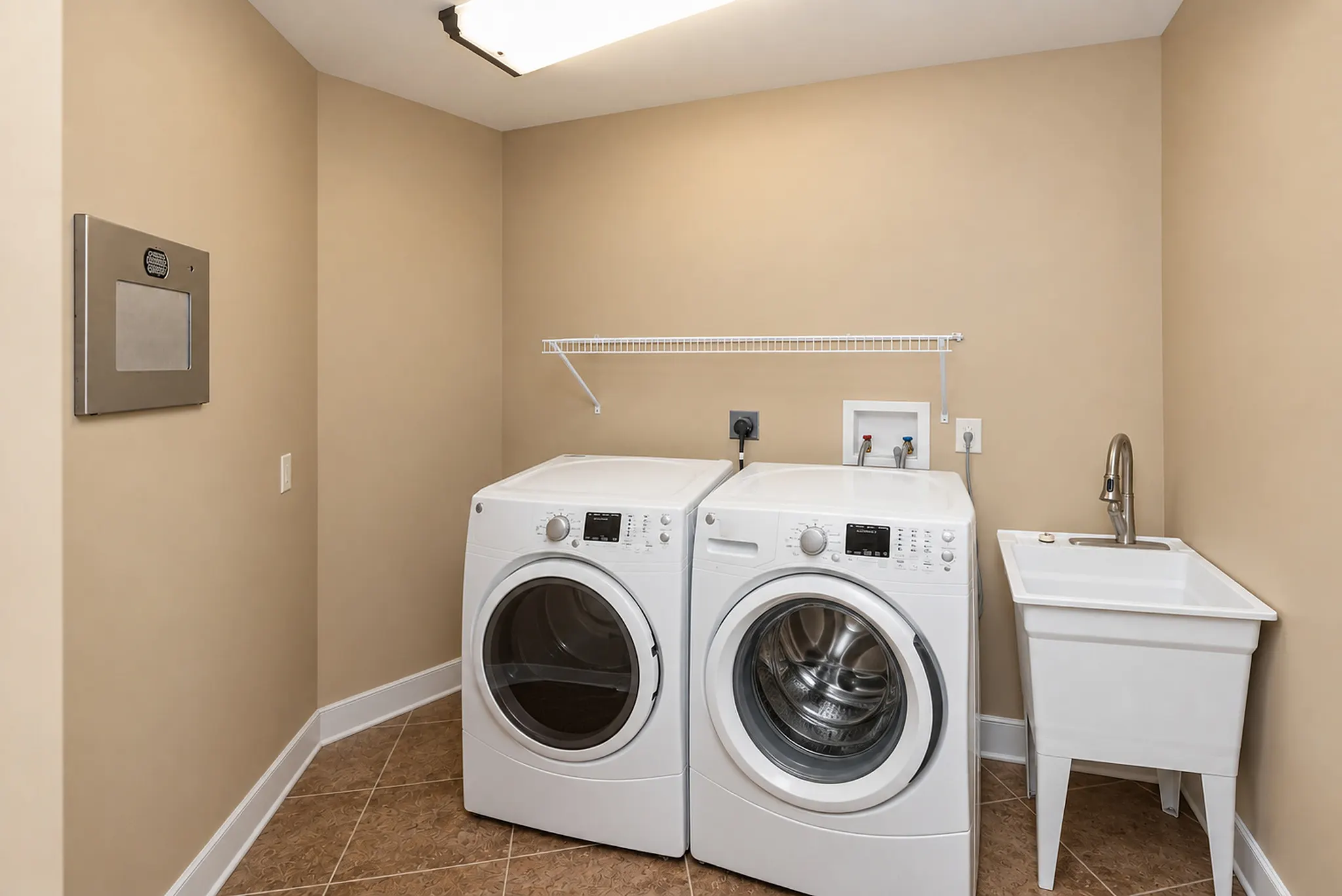 Laundry room with a full-size washer, dryer and utility sink
