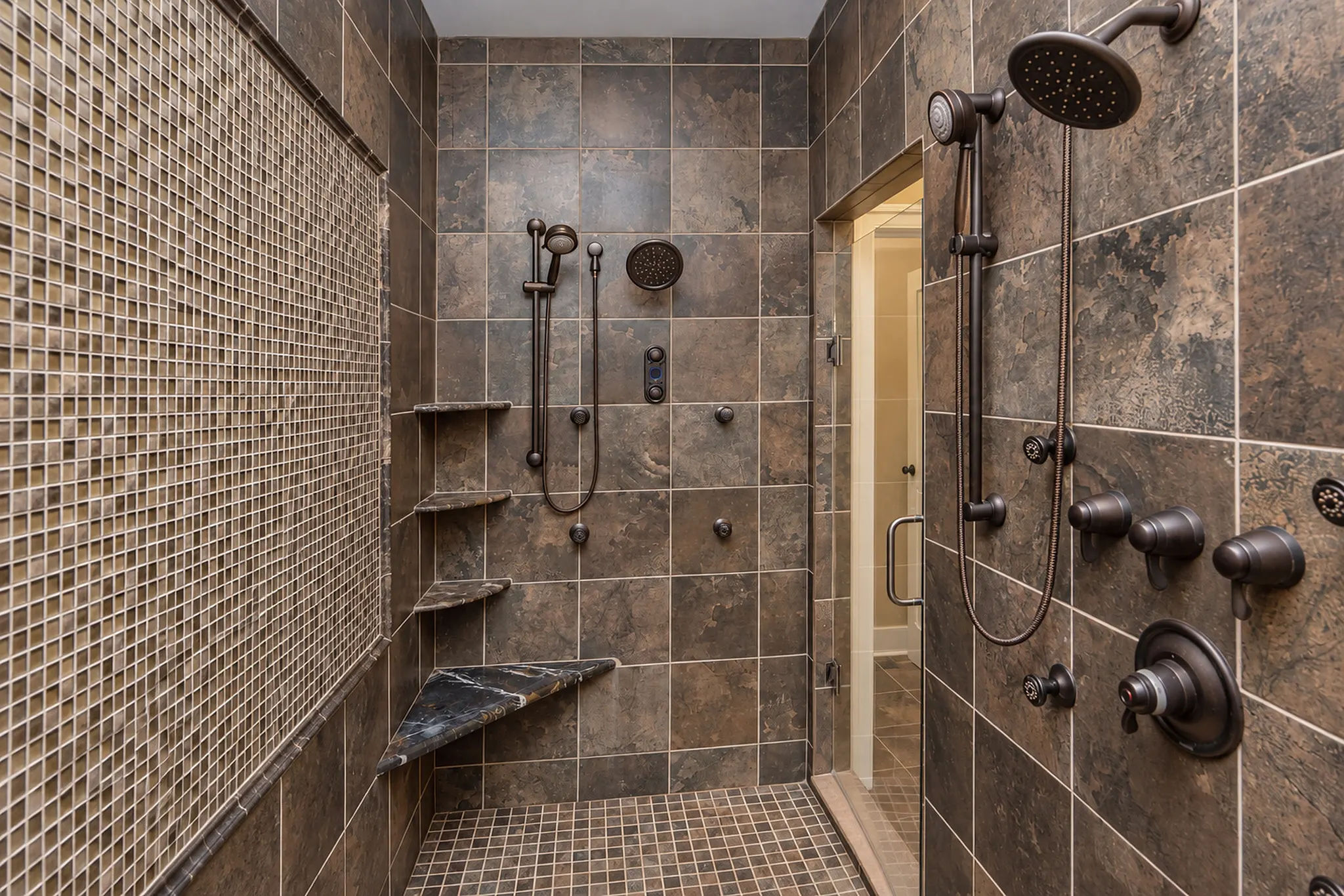 Primary bathroom’s oversized walk-in shower with two stations