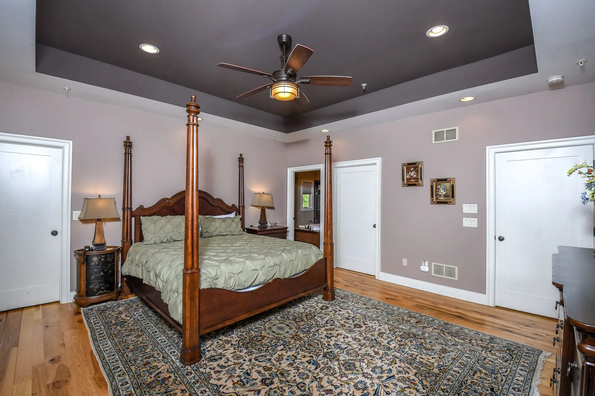 Main level primary suite with a four-poster king bed