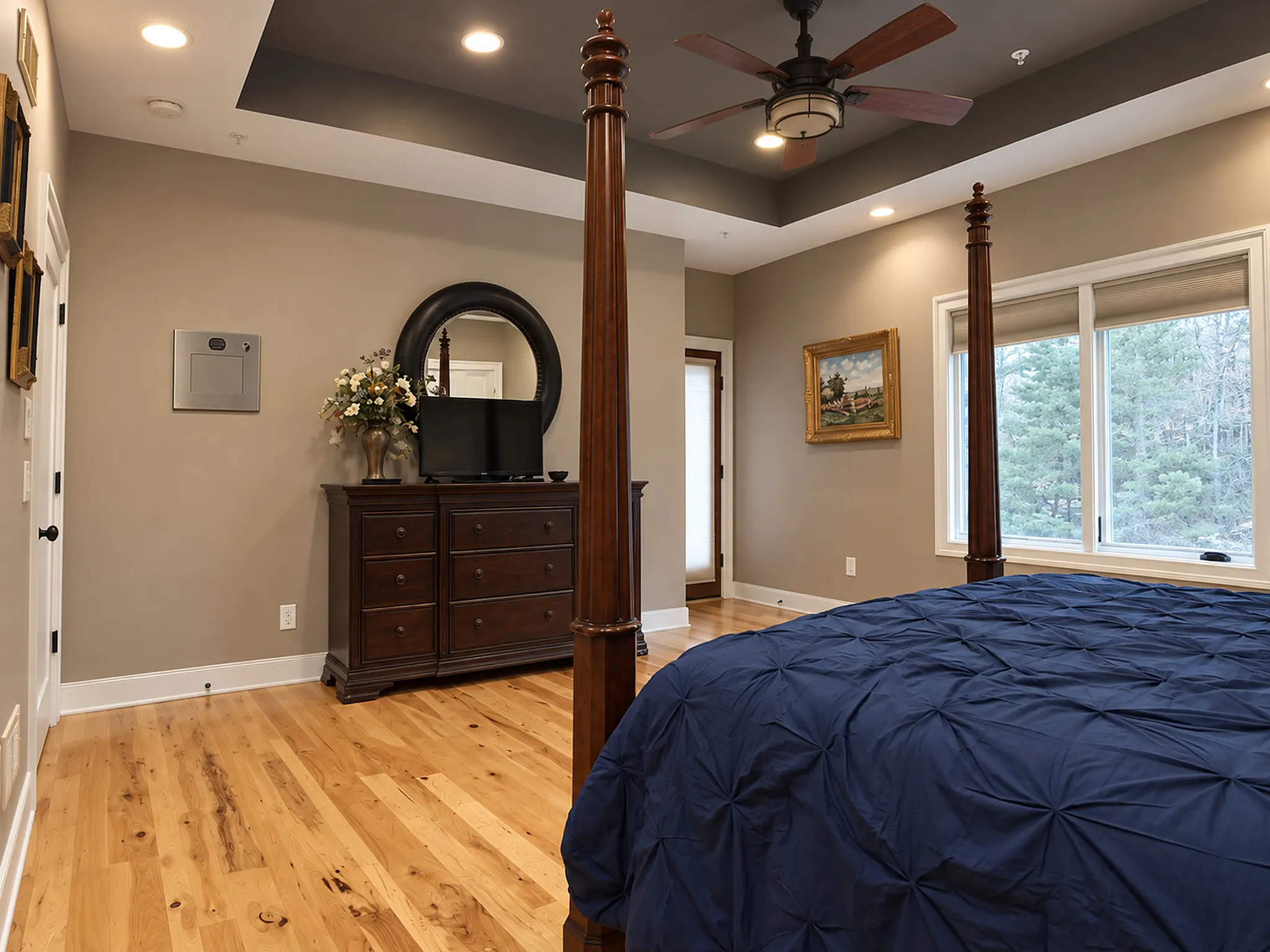 Primary suite dresser and TV beneath the tray ceiling