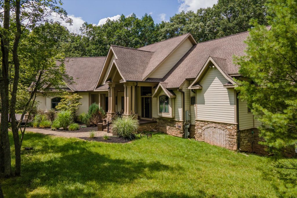 Woodland Chalet exterior with driveway approach through mature forest