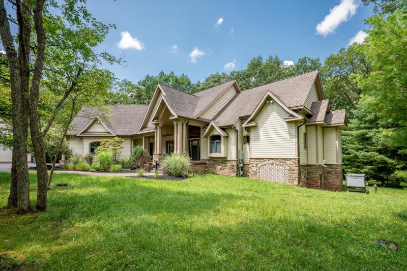 Woodland Chalet front exterior nestled among tall trees at Deep Creek Lake