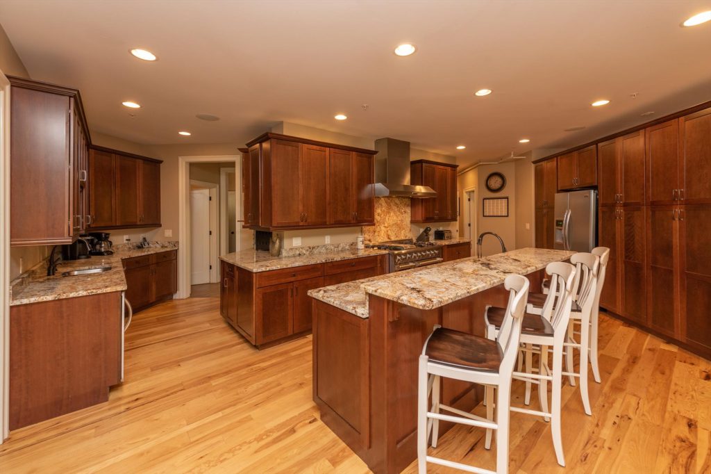 Open kitchen layout connecting to dining and living areas at Woodland Chalet