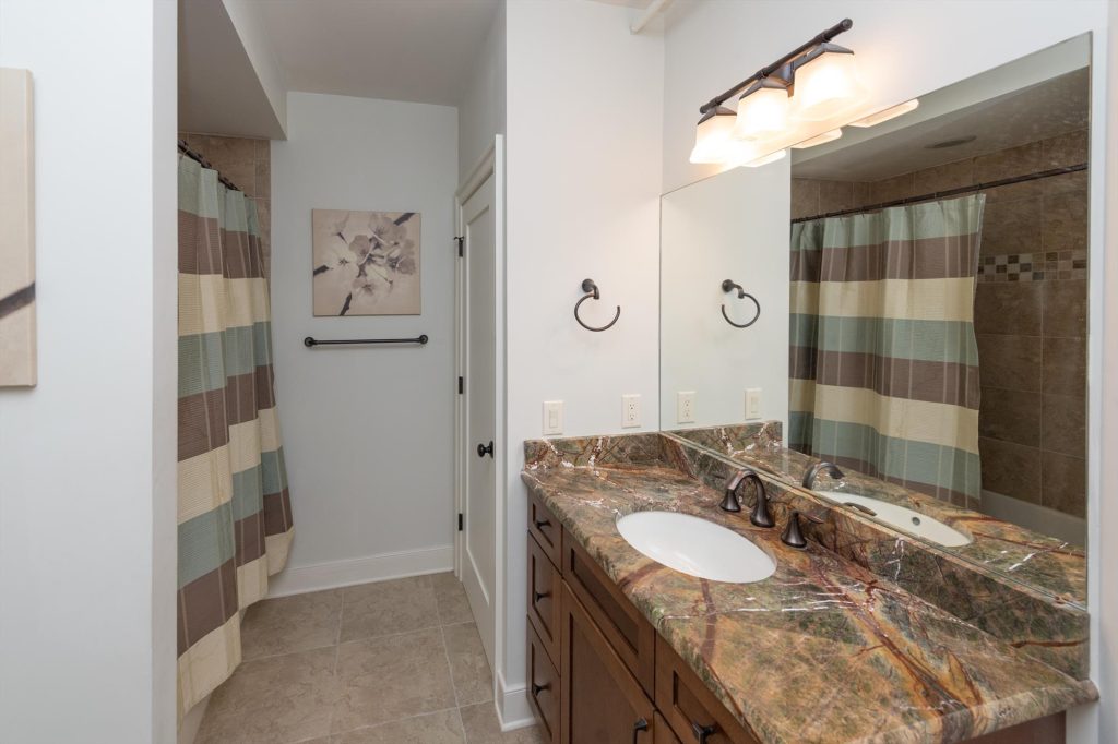Lower level main bathroom accessible from the game room and common areas