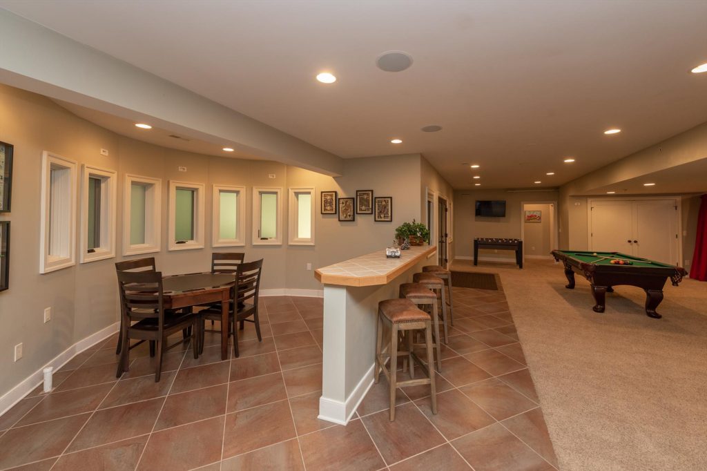Cozy lower level den with comfortable seating and entertainment options
