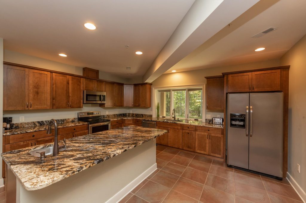 Lower level kitchen with full-size appliances and breakfast bar seating