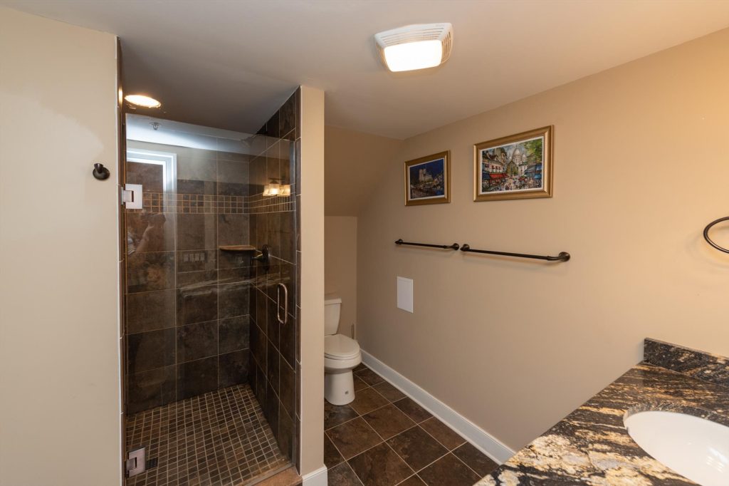 Lower level primary suite ensuite bathroom with modern fixtures