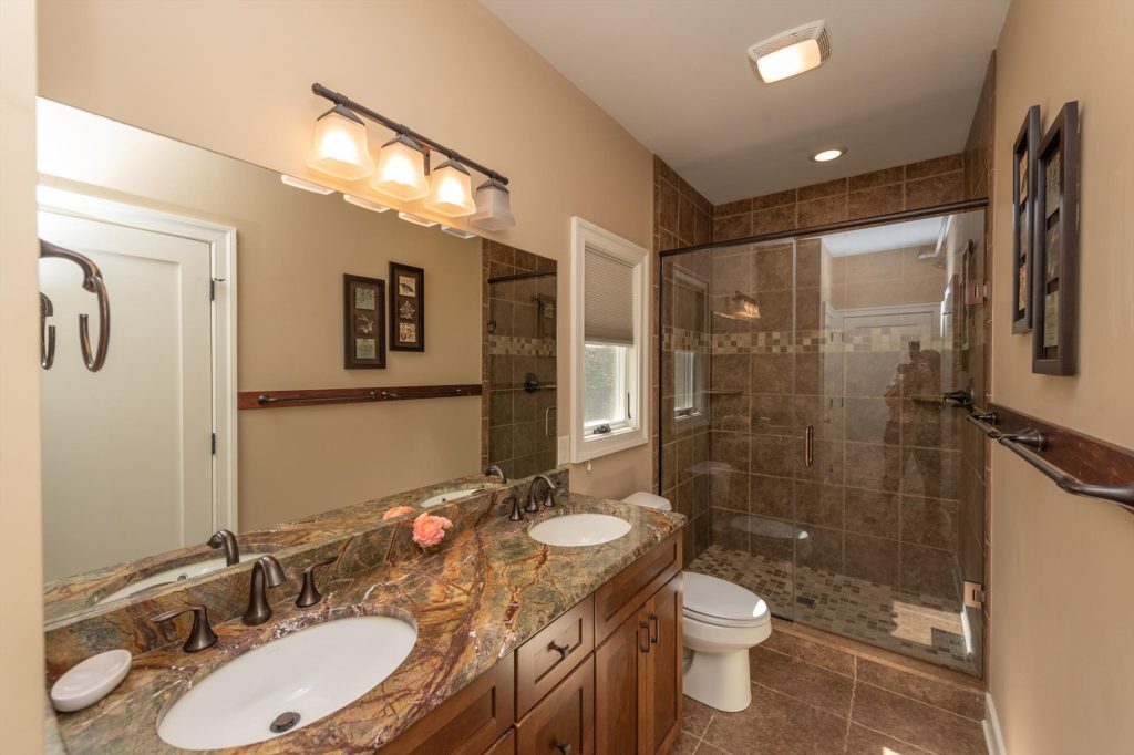 Main level full bathroom with tub-shower combination and vanity