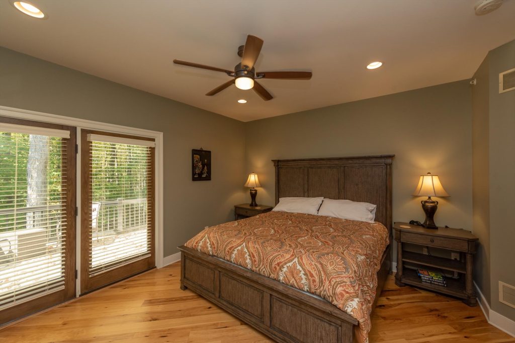 Main level bedroom with king bed and cozy mountain cabin decor