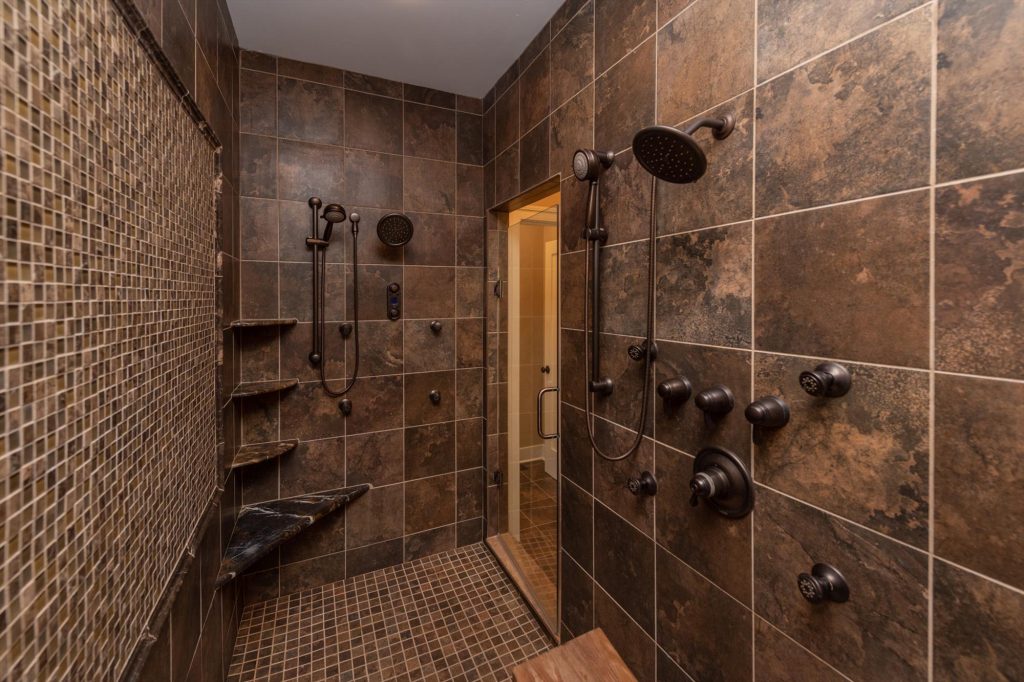 Walk-in shower with tile surround in the master suite bathroom