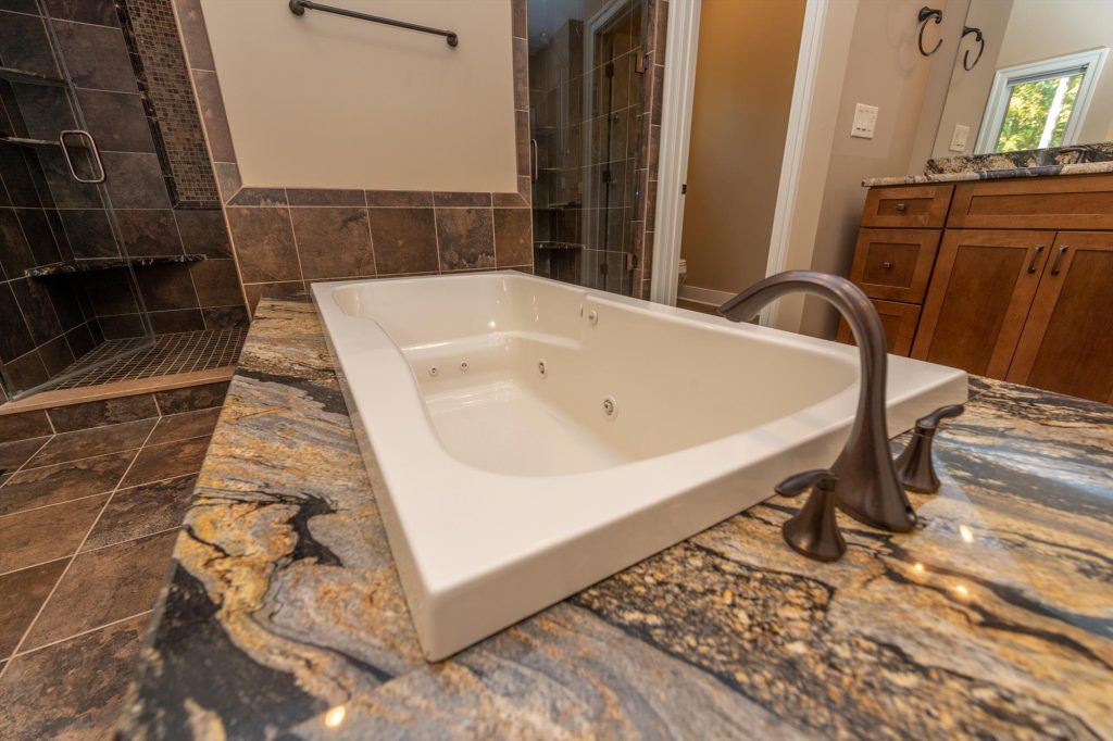 Oversized jetted soaking tub in the master suite bathroom for relaxation
