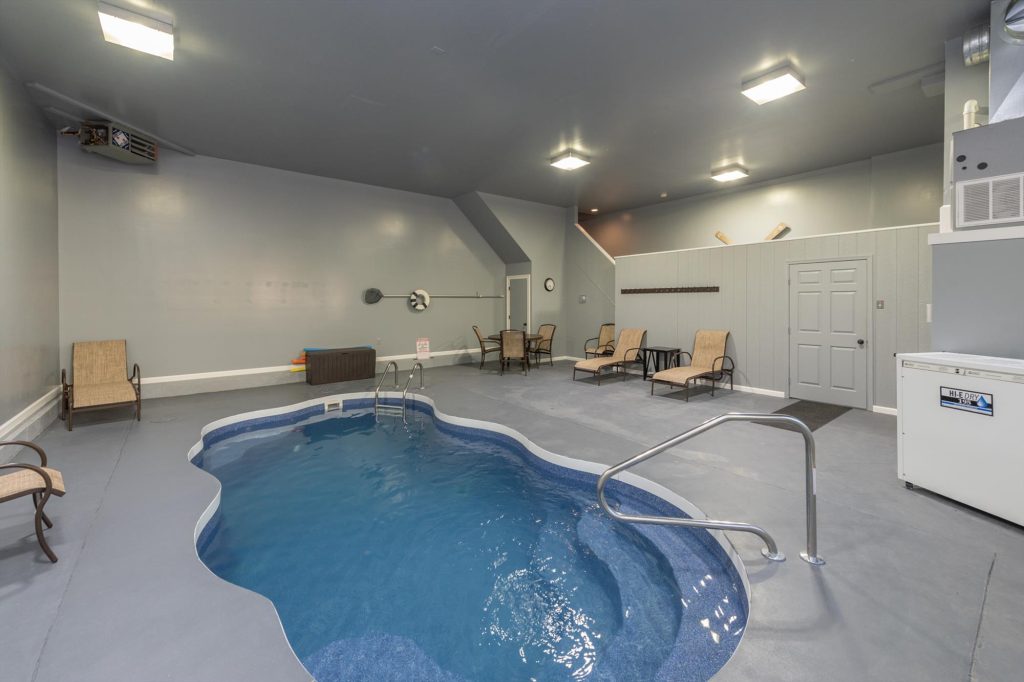 Indoor pool room with ample natural light in the 30-by-28-foot pool house
