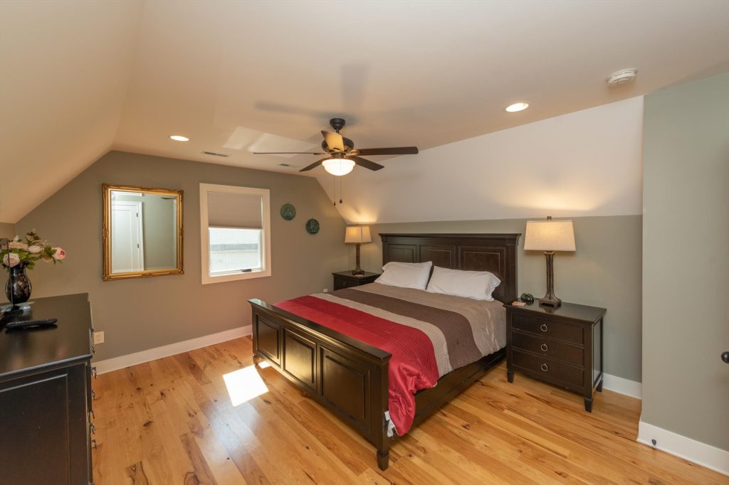Upper level bedroom alternate view showing spacious layout and decor